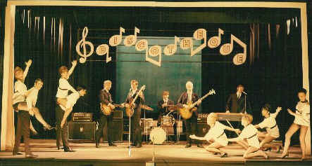The Tornados on stage at the Windmill Theatre in Great Yarmouth in Norfolk during the summer season show of 1967.  Left to right....Pete Holder playing Gibson 335 right handed (Pete plays left handed)...Dave Watts, organist (Playing rhythm guitar)...Roger Holder, bass guitarist (Playing Drums)...John Davies, Drummer (Playing Bass guitar).....Robb Huxley, vocalist, Guitarist (Playing Keyboard) plus the Fox - Miller Boys and Girls.